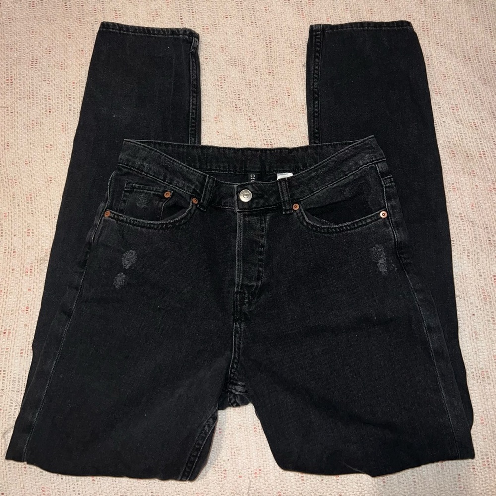 Divided black jeans with slight knee rips